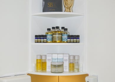 Shelves of beauty products at SB Cosmetics Clinic, Glasgow, Scotland, GB, showcasing a range of skincare oils and creams.