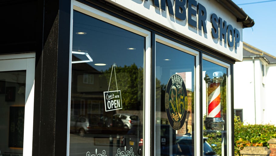 DG barbershop exterior with open sign, Guildford, England, GB.