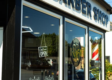 DG barbershop exterior with open sign, Guildford, England, GB.