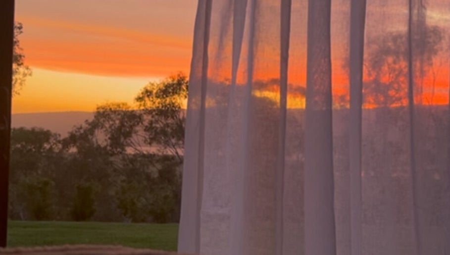 Peaceful sunset view through curtains at Face Lane, Castlereagh, New South Wales, AU.