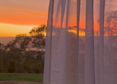 Peaceful sunset view through curtains at Face Lane, Castlereagh, New South Wales, AU.