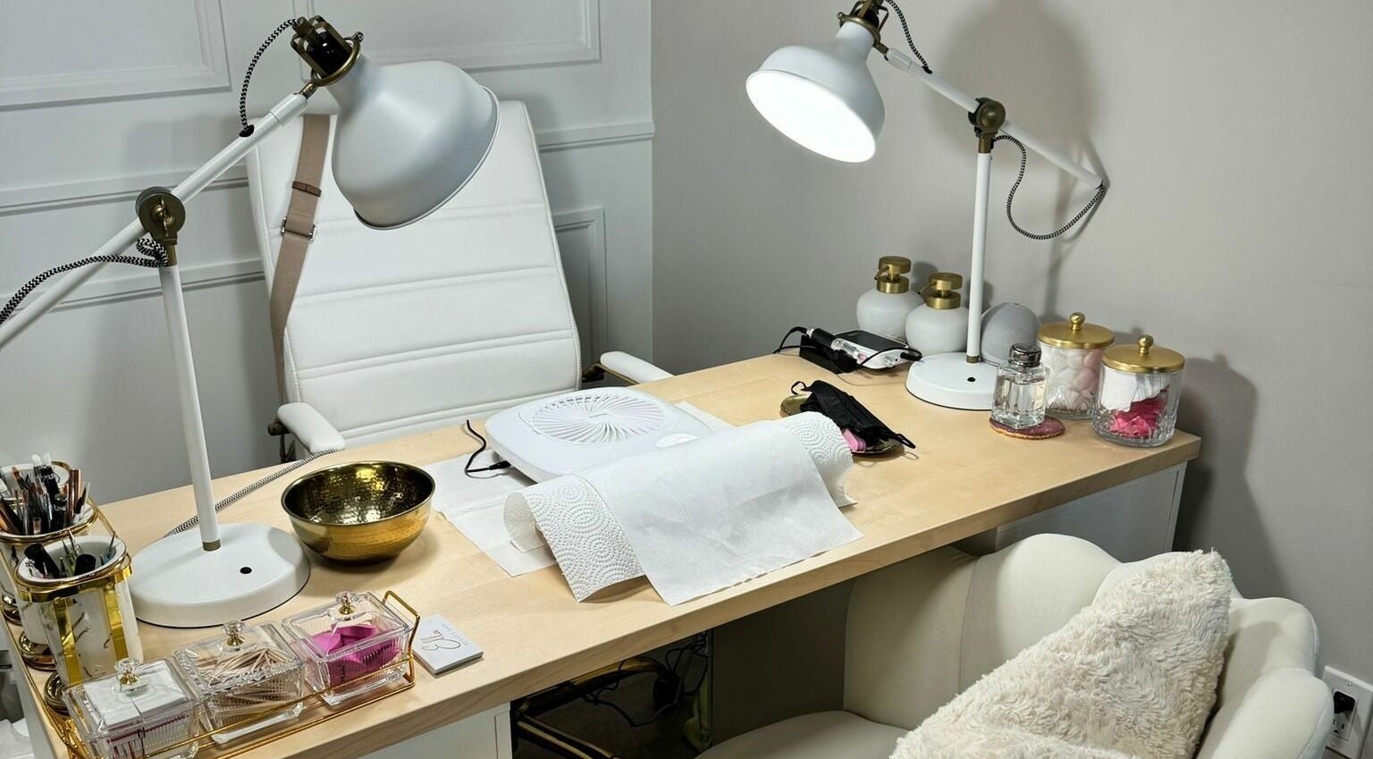 Elegant nail station setup at Ella Beauty Bar in Thorold, Ontario, CA with cozy chair and organized tools.