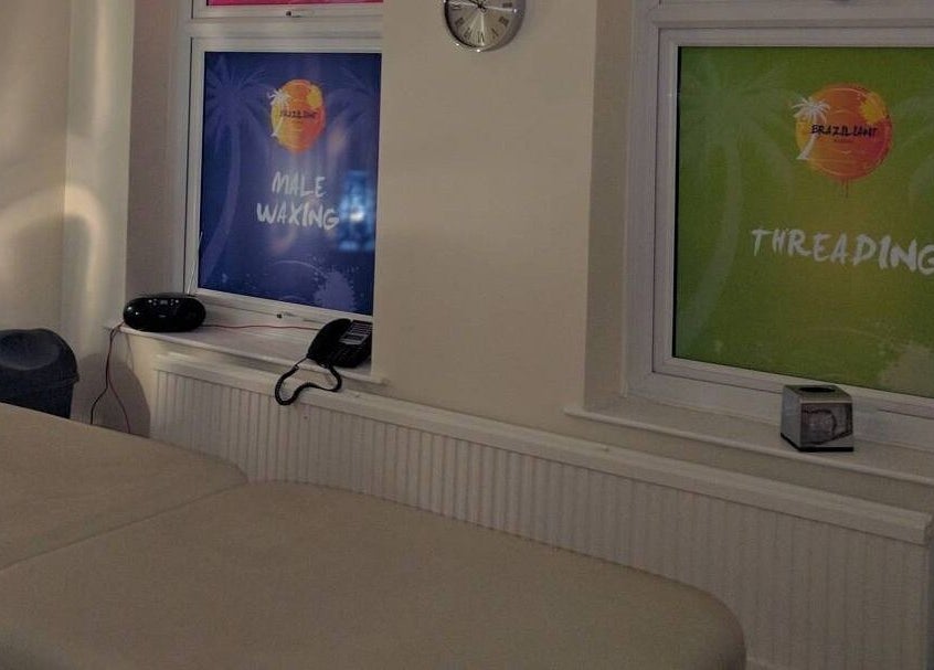 Interior of Braziliant Waxing Haydn Road in Nottingham, England, showcasing massage beds and relaxing décor.