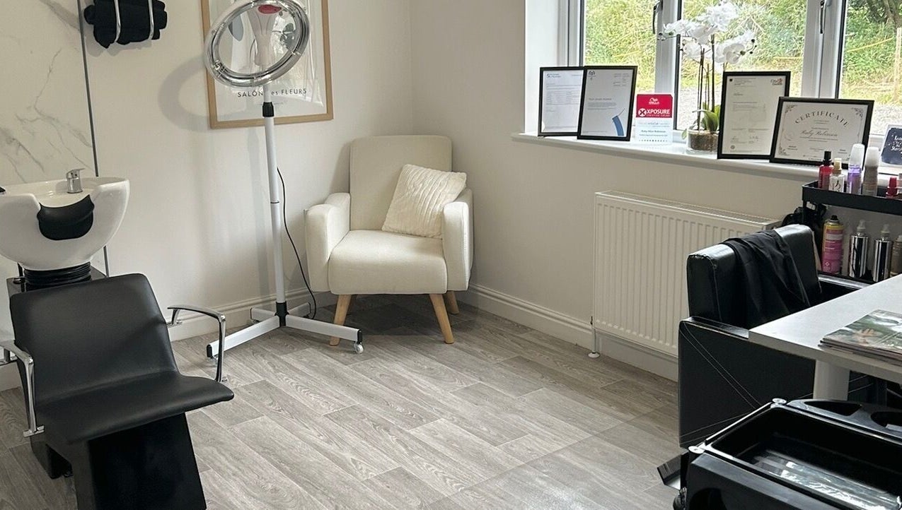 Cozy styling corner at Ruby Alice Hair in Broughton, England, GB featuring sleek salon chair and products.