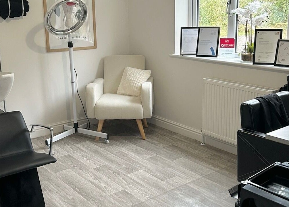 Cozy styling corner at Ruby Alice Hair in Broughton, England, GB featuring sleek salon chair and products.