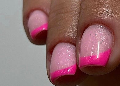 Beautiful pink glitter nails with French tips at Beauty Muse (BLEND), Skewen, Wales, GB. Glamorous nail art.