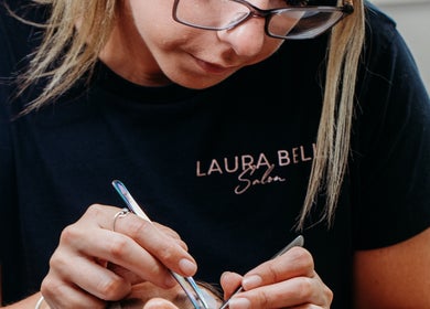 Laura Bell Salon beautician performing eyebrow shaping in Falmouth, England, GB.