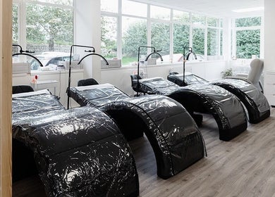 Relaxing treatment area at Laura Bell Salon, Falmouth, England, GB, with modern reclining chairs.