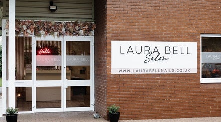 Entrance of Laura Bell Salon, Falmouth, England, showcasing elegant decor and welcoming sign.