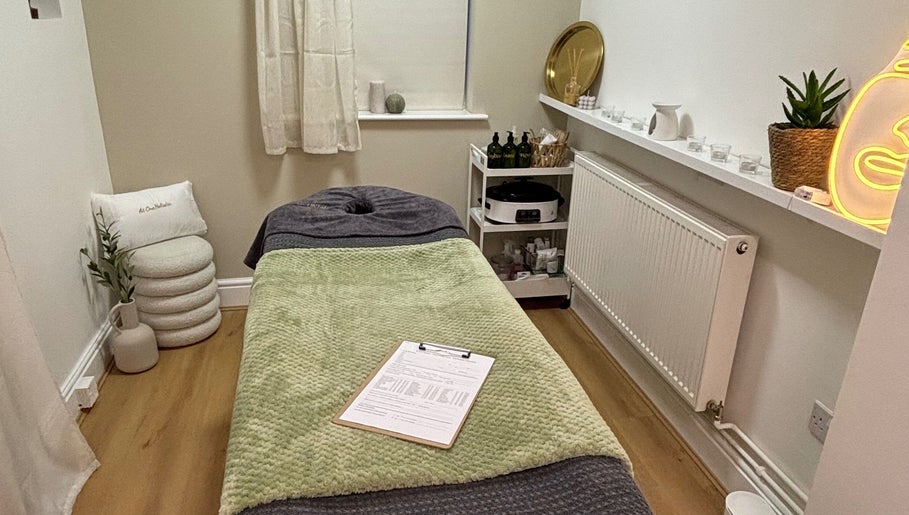 Calming treatment room at At One Holistic Wellbeing, Halesowen, England, GB, featuring a massage bed and decor.