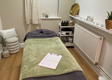 Calming treatment room at At One Holistic Wellbeing, Halesowen, England, GB, featuring a massage bed and decor.
