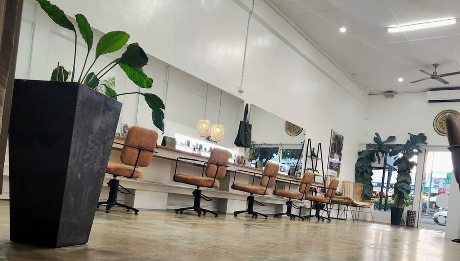Elegant interior of Suede Hair Skin Body in Cairns City, Queensland, AU, showcasing stylish salon chairs and greenery.