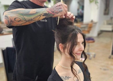 Stylist creating elegant hair updo at Suede Hair Skin Body in Cairns City, Queensland, AU.