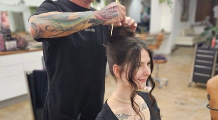 Stylist creating elegant hair updo at Suede Hair Skin Body in Cairns City, Queensland, AU.