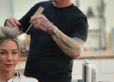 Professional hairstylist crafts elegant hairdo at Suede Hair Skin Body, Cairns City, Queensland, AU.