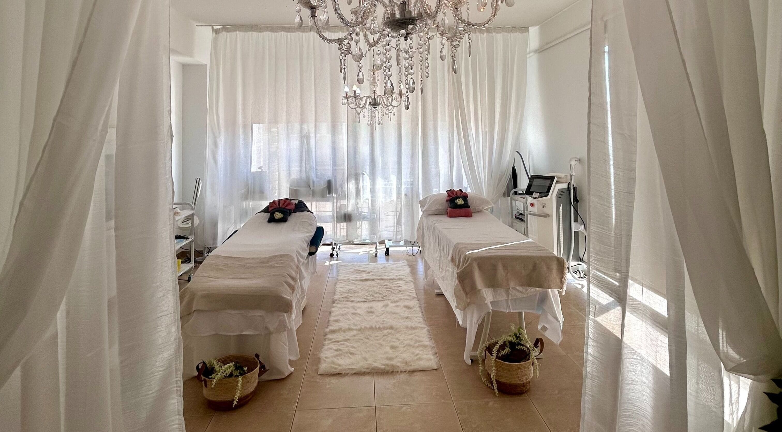 Luxurious spa room at At U Beauty, Kokkinotrimithia, Nicosia, CY featuring massage beds and elegant chandelier.