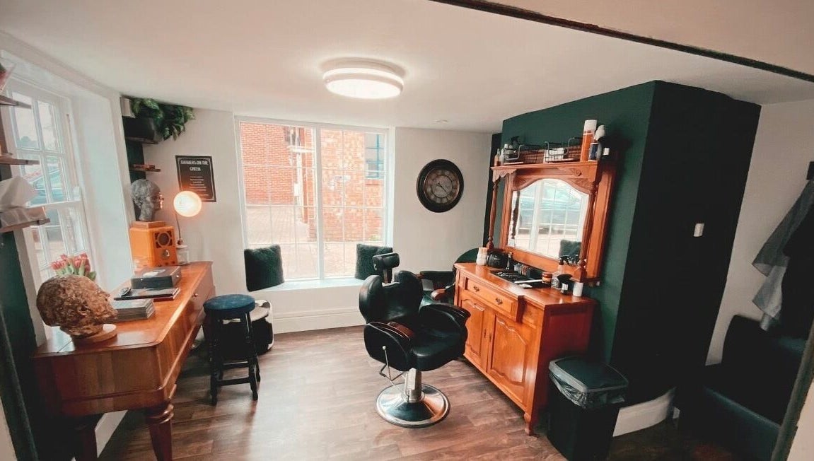 Chic interior of Barbers on the Green Rowlands Castle, Rowlands Castle, England, GB. Stylish barber chair and decor.