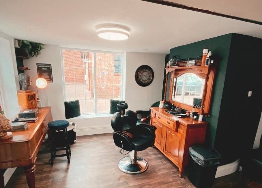 Chic interior of Barbers on the Green Rowlands Castle, Rowlands Castle, England, GB. Stylish barber chair and decor.