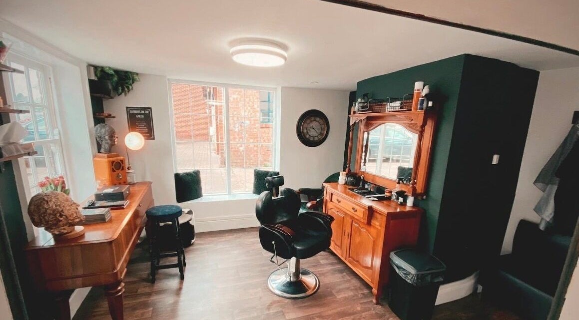 Chic interior of Barbers on the Green Rowlands Castle, Rowlands Castle, England, GB. Stylish barber chair and decor.