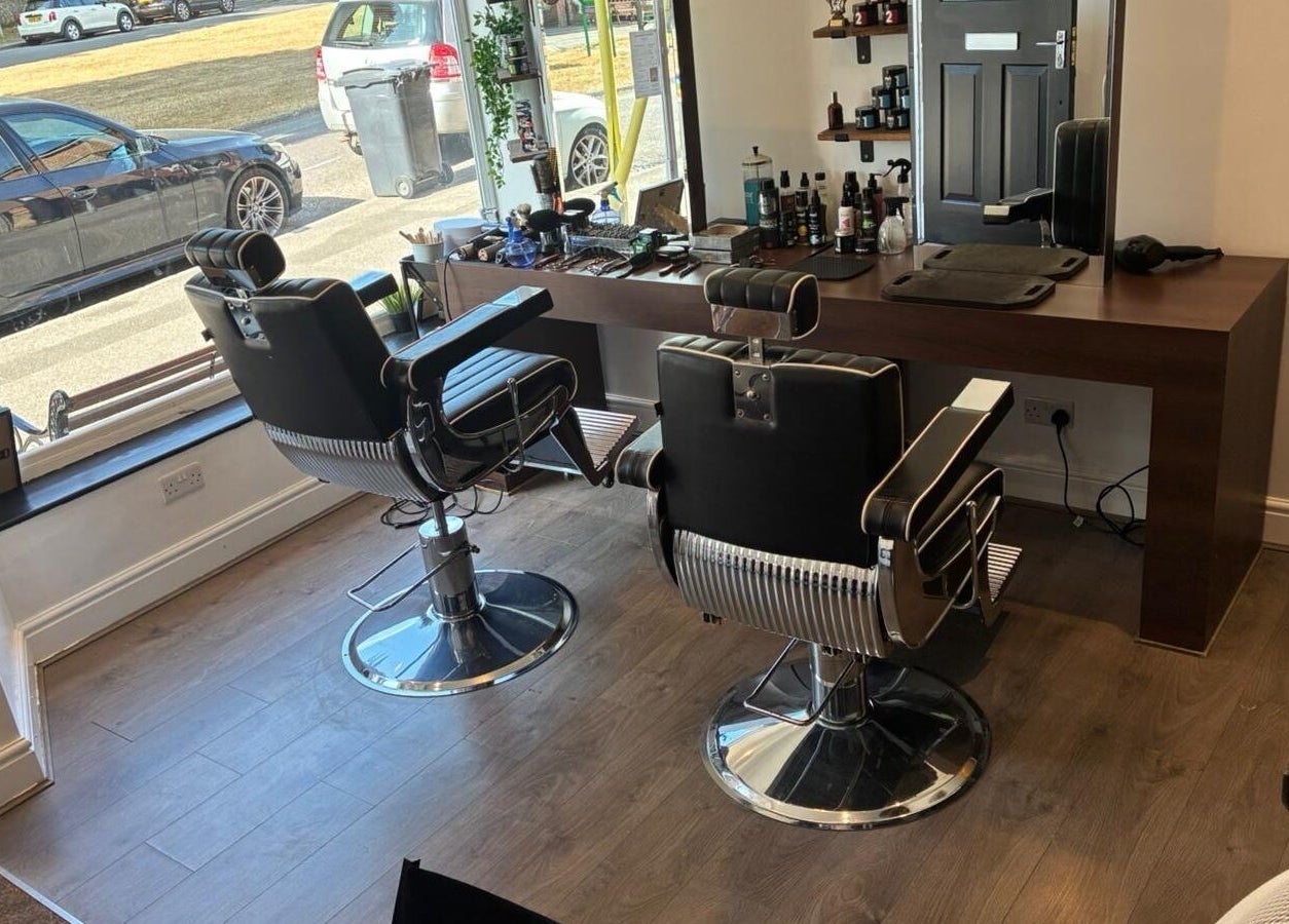 Interior of Barbers on the Green Rowlands Castle, Rowlands Castle, England, showcasing modern barber chairs.