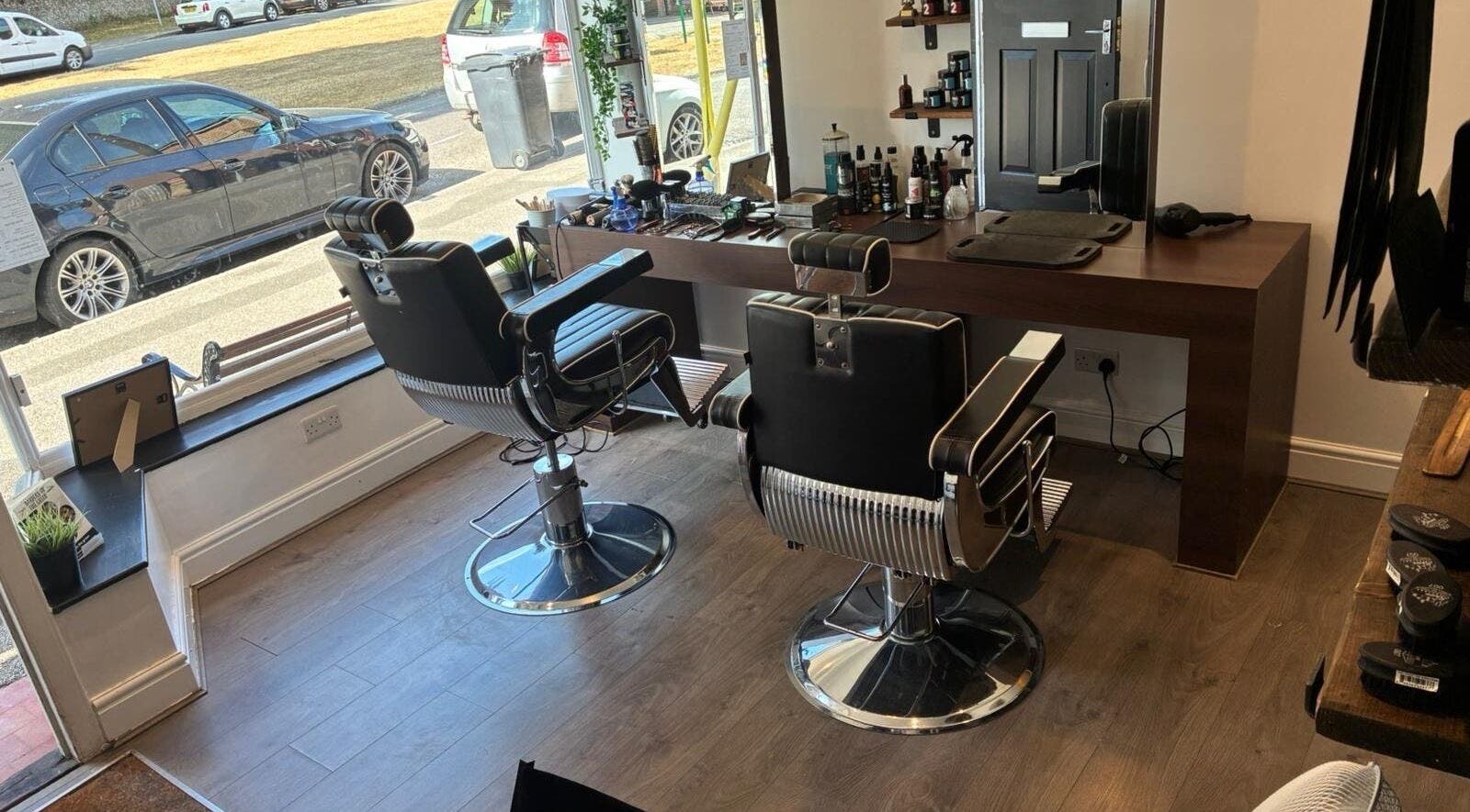 Interior of Barbers on the Green Rowlands Castle, Rowlands Castle, England, showcasing modern barber chairs.