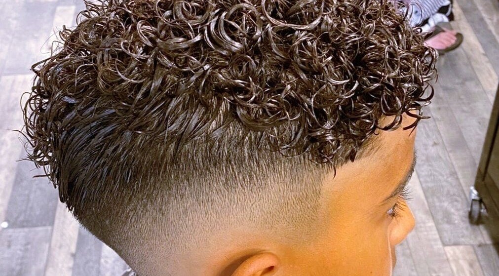 Close-up of curly hairstyle expertly crafted at Barbers On The Green Havant, Havant, England, GB.