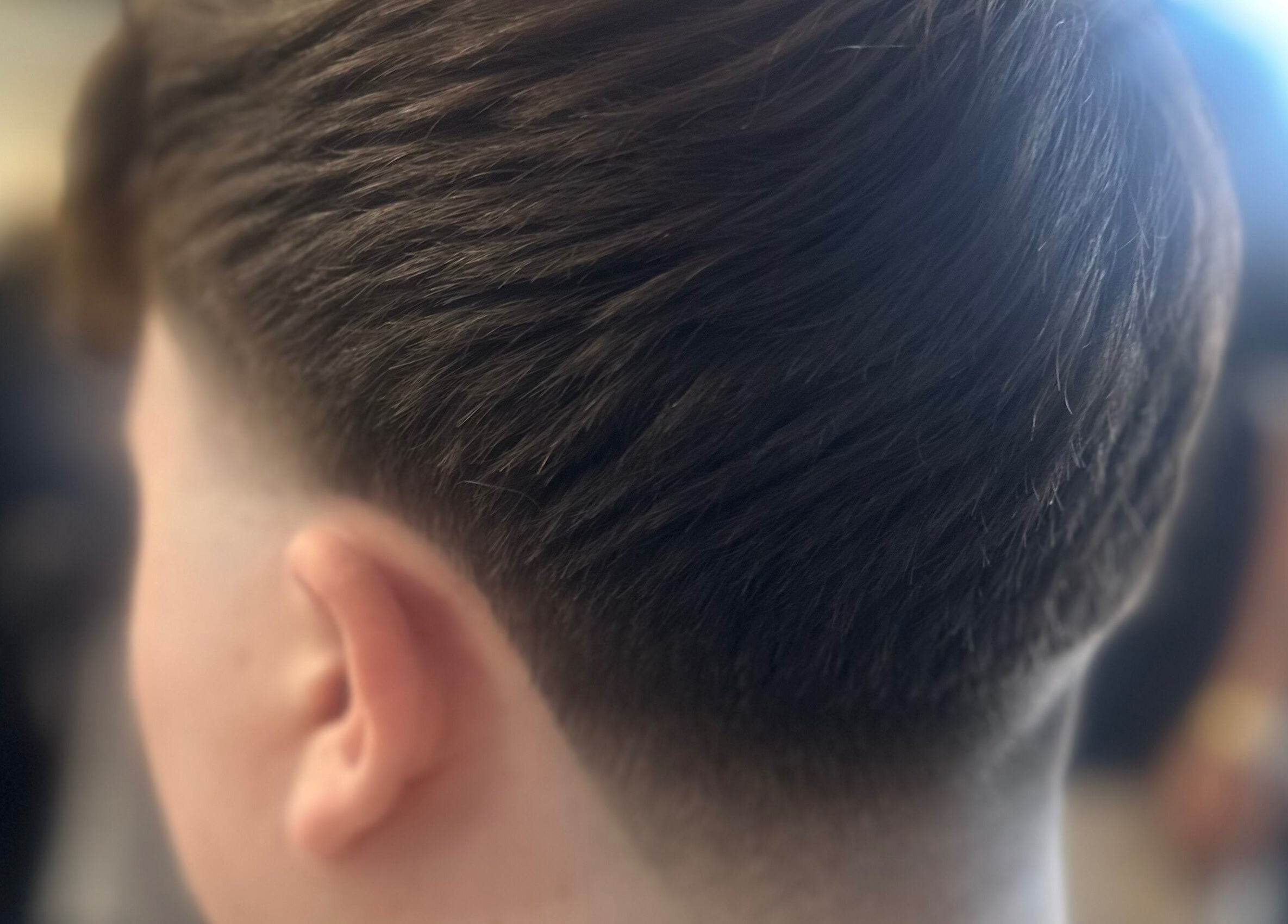 Close-up of a modern fade haircut at Barbers On The Green Havant, located in Havant, England, GB.