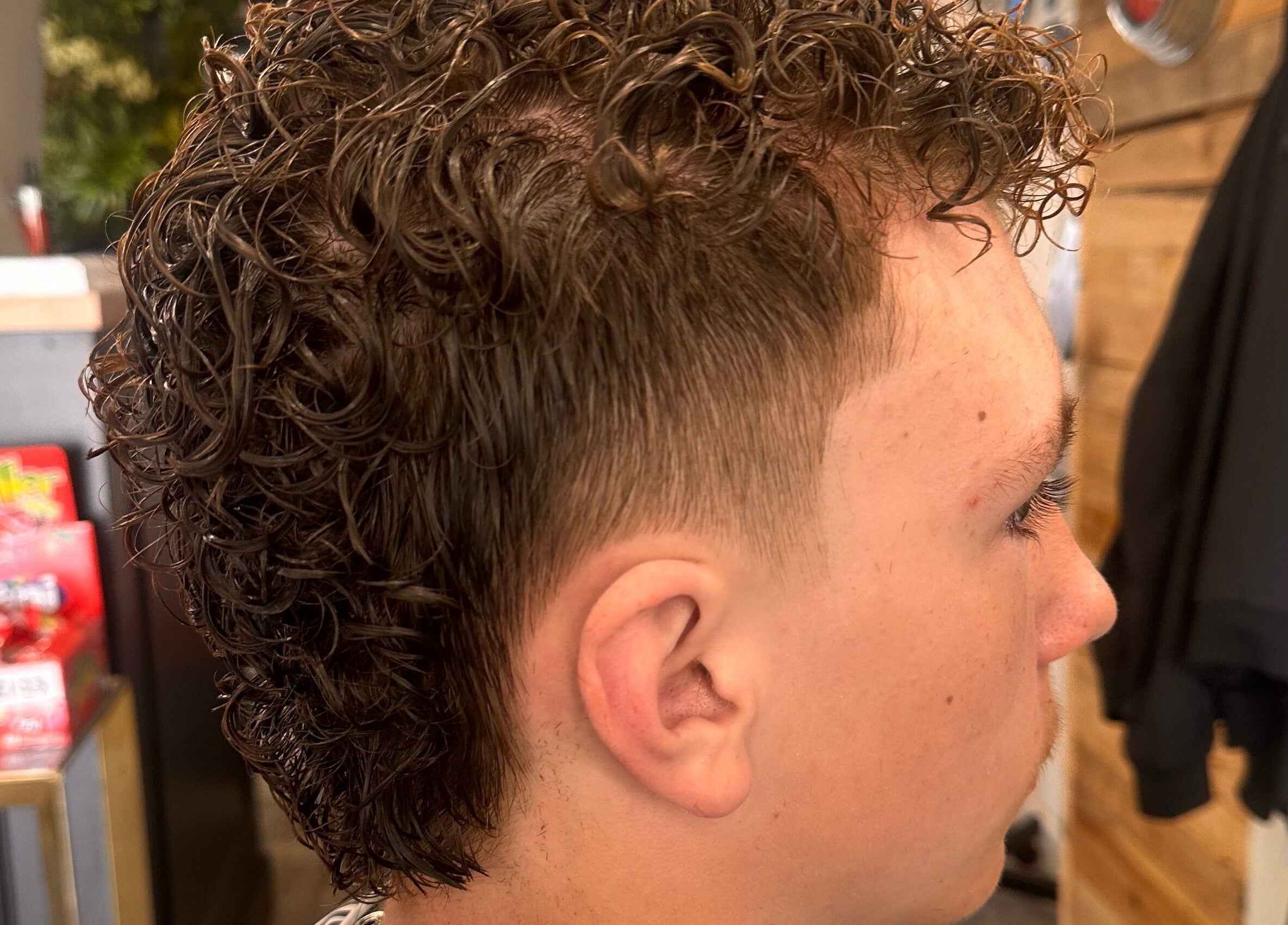 Close-up of a stylish curly haircut at Barbers On The Green Havant, Havant, England, GB.
