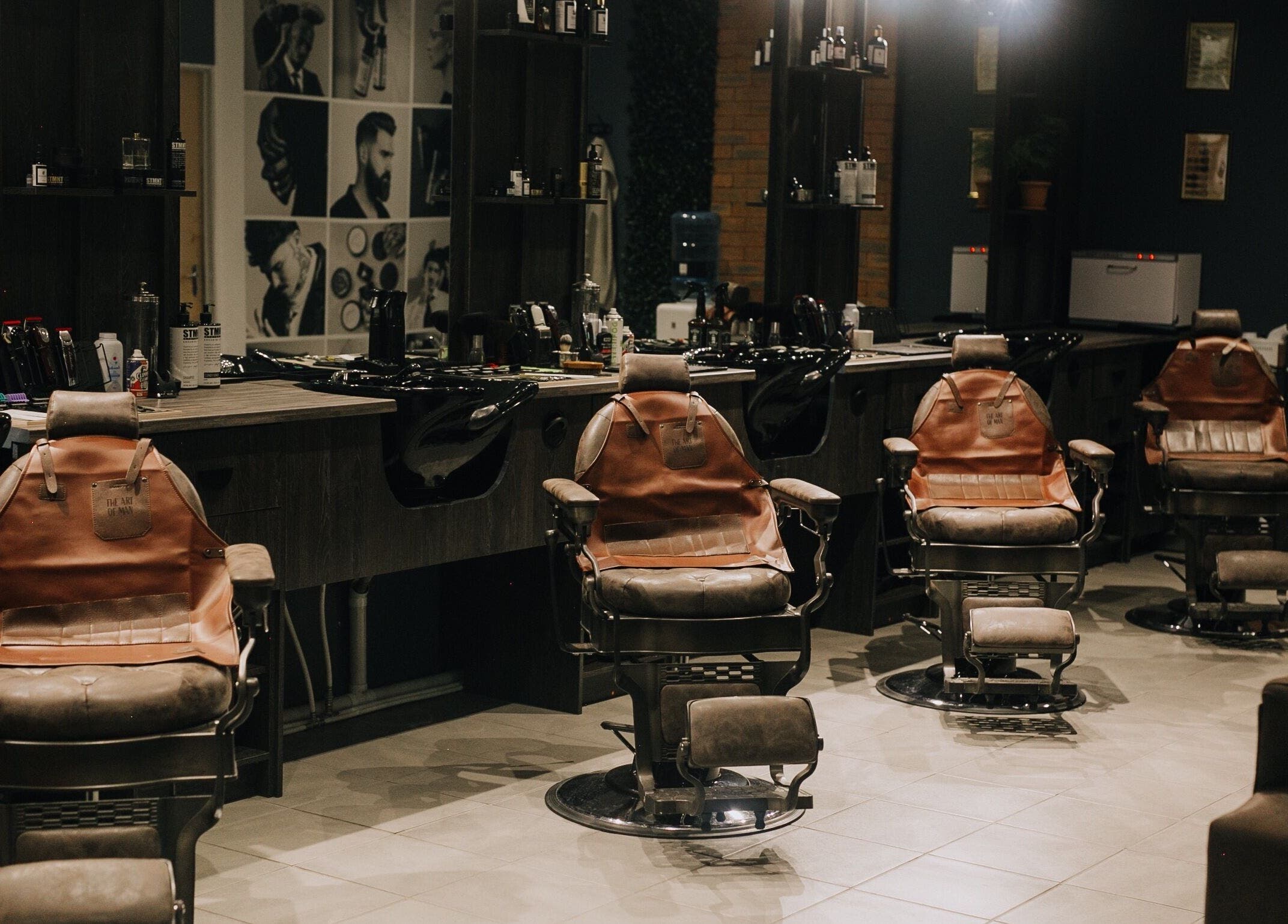 Stylish barber chairs at The Art of Man in Pretoria, Gauteng, ZA, offering a modern grooming experience.
