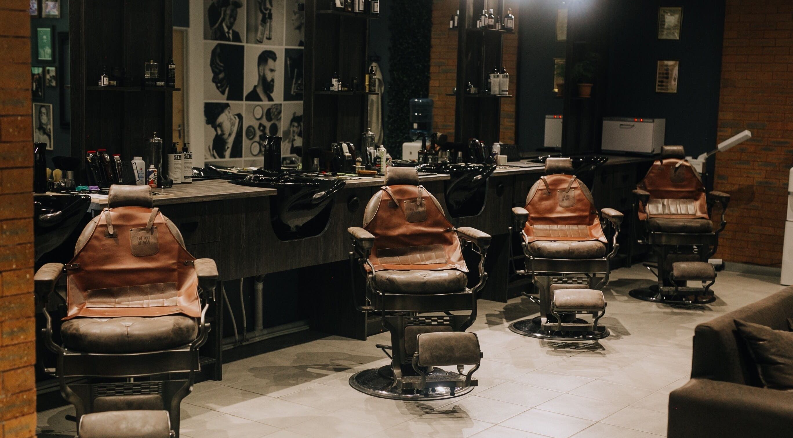 Stylish barber chairs at The Art of Man in Pretoria, Gauteng, ZA, offering a modern grooming experience.