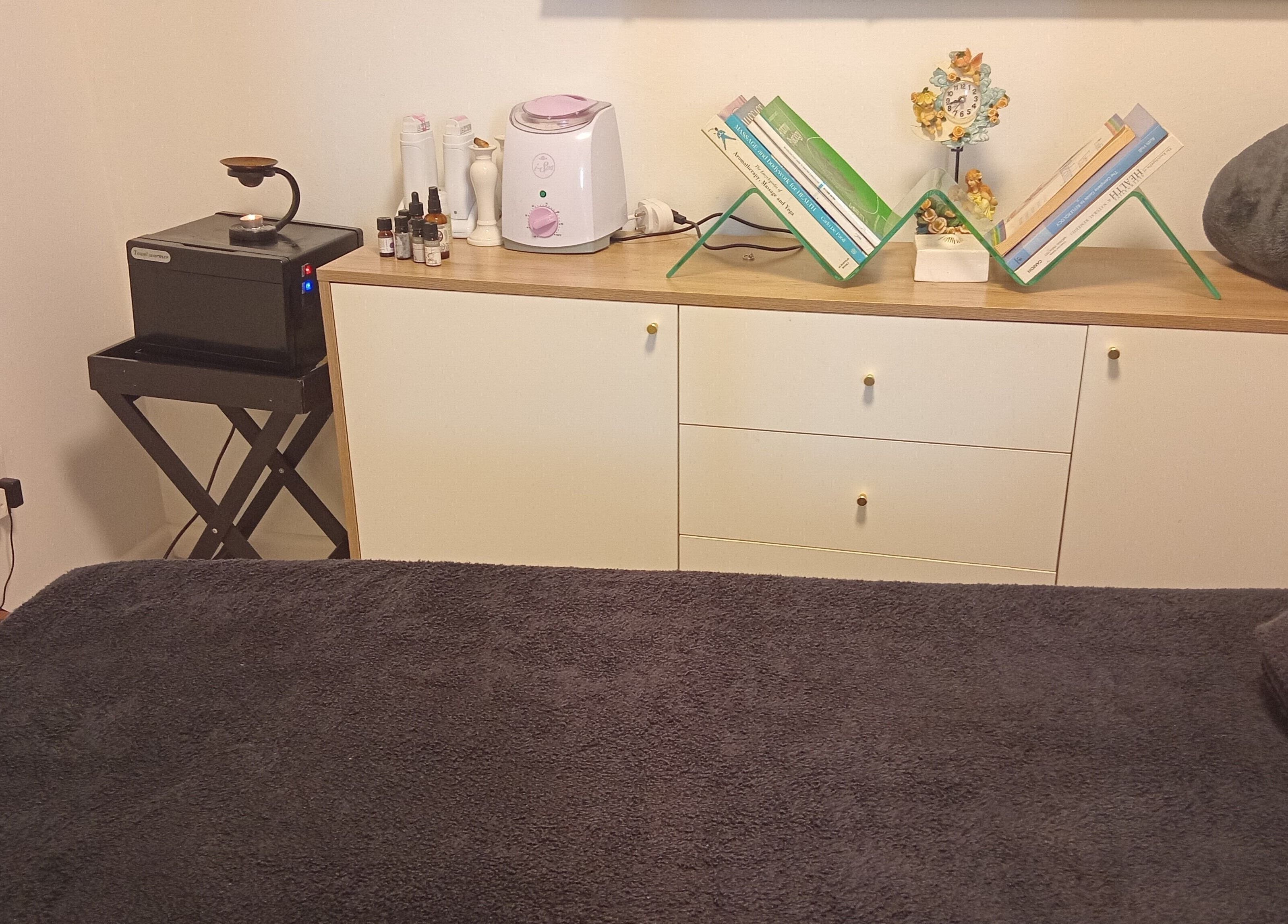 Cozy massage room at Ithongo in Cape Town, Western Cape, ZA, featuring plush towels and soothing decor.