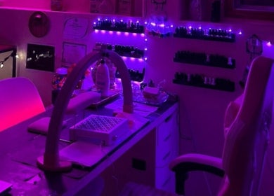 Charmed Nailzz nail studio in Red Deer, Alberta, CA, illuminated with calming purple lights for a serene vibe.