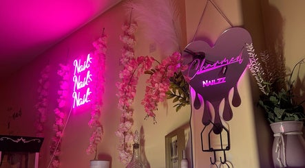 Charmed Nailzz neon sign with pink blossoms, Red Deer, Alberta, CA.