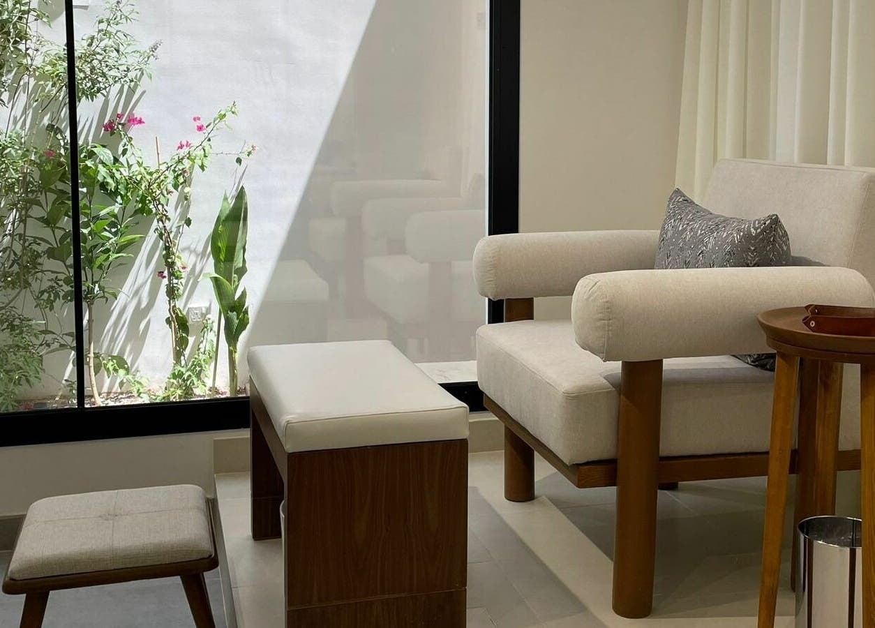 Relaxing seating area at Ling Spa I لنق سبا, Riyadh. Elegant decor with natural light and greenery.