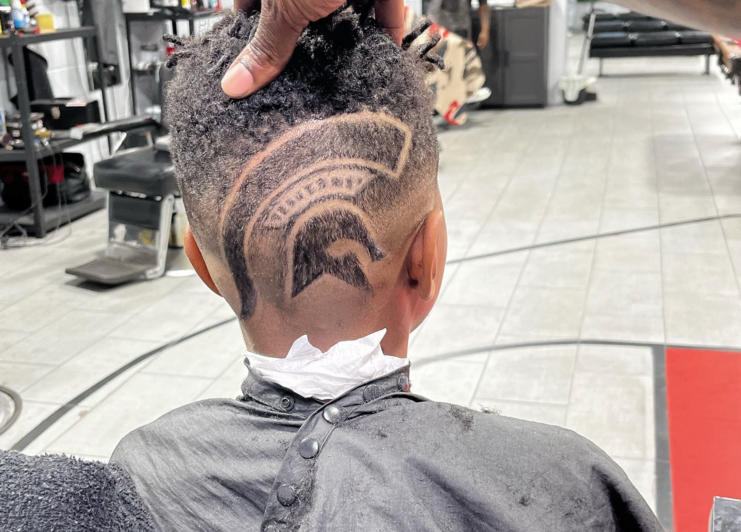 Unique youth hairstyle design at Den Of Flavor, Lathrup, Michigan, US, showcasing skillful barber art.