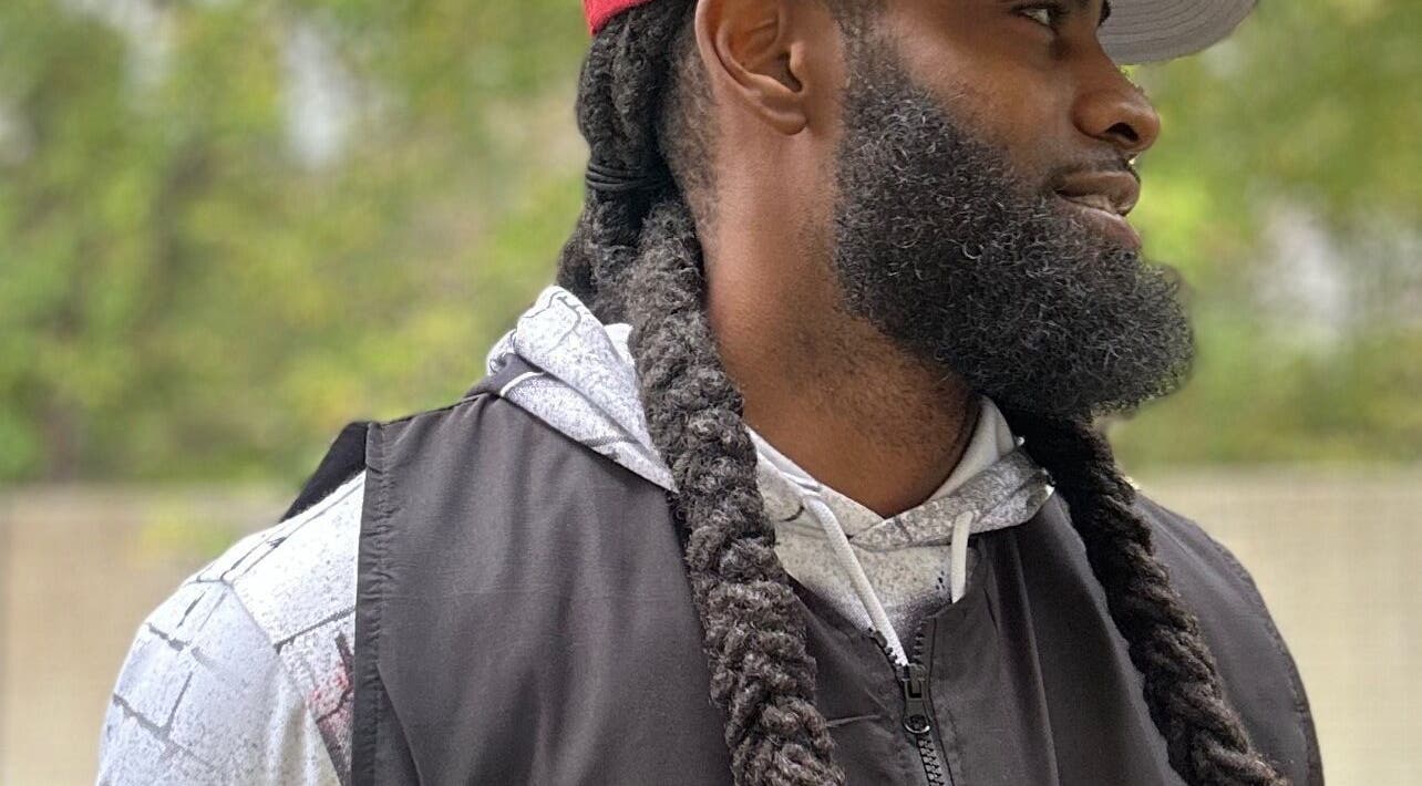 Stylish beard and long braids showcased at Den Of Flavor in Lathrup, Michigan, US.