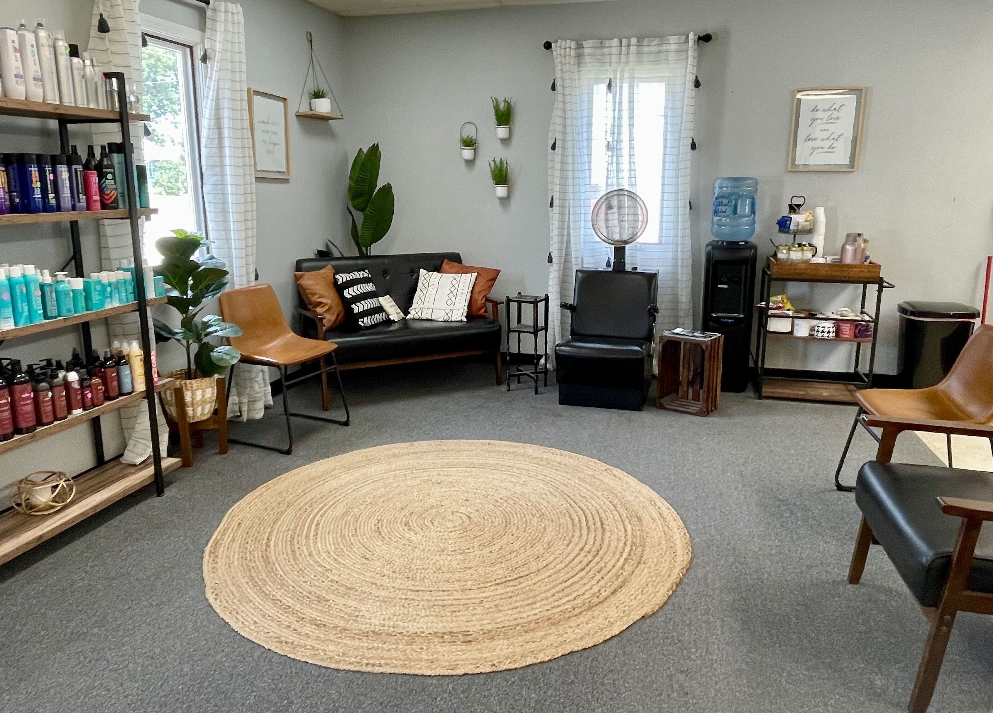 Elegant salon lounge at Emily Beck Esthetics at The Upper Cut, Bryan, Ohio with modern decor and product display.