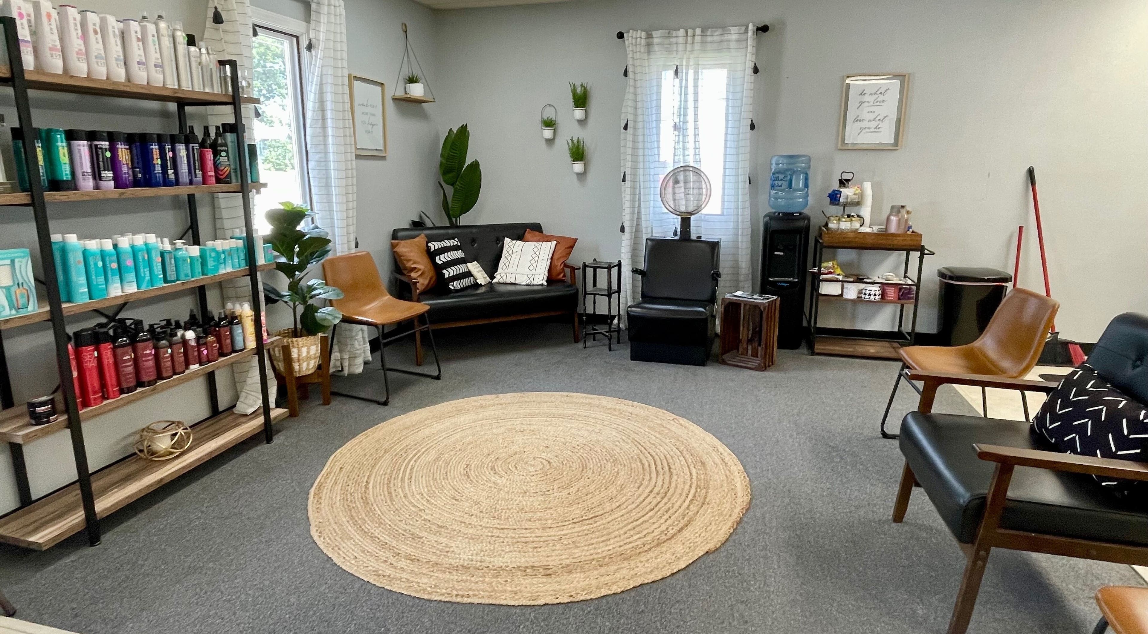 Elegant salon lounge at Emily Beck Esthetics at The Upper Cut, Bryan, Ohio with modern decor and product display.