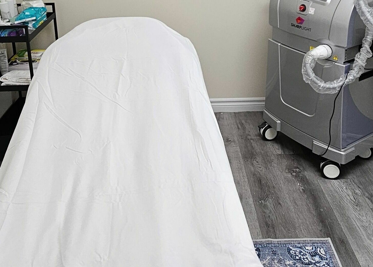 Treatment room at Your Choice Salon And Spa, Mississauga, Ontario, CA with a bed and laser machine.