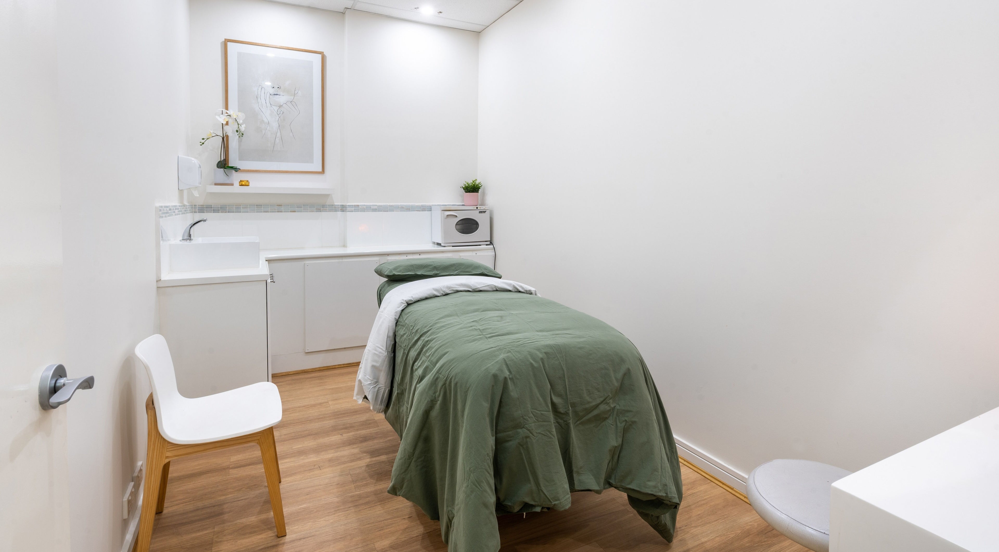 Serene treatment room at Kay + Co Cosmetic Rejuvenation - Highett, in Highett, Victoria, AU featuring a cozy bed.