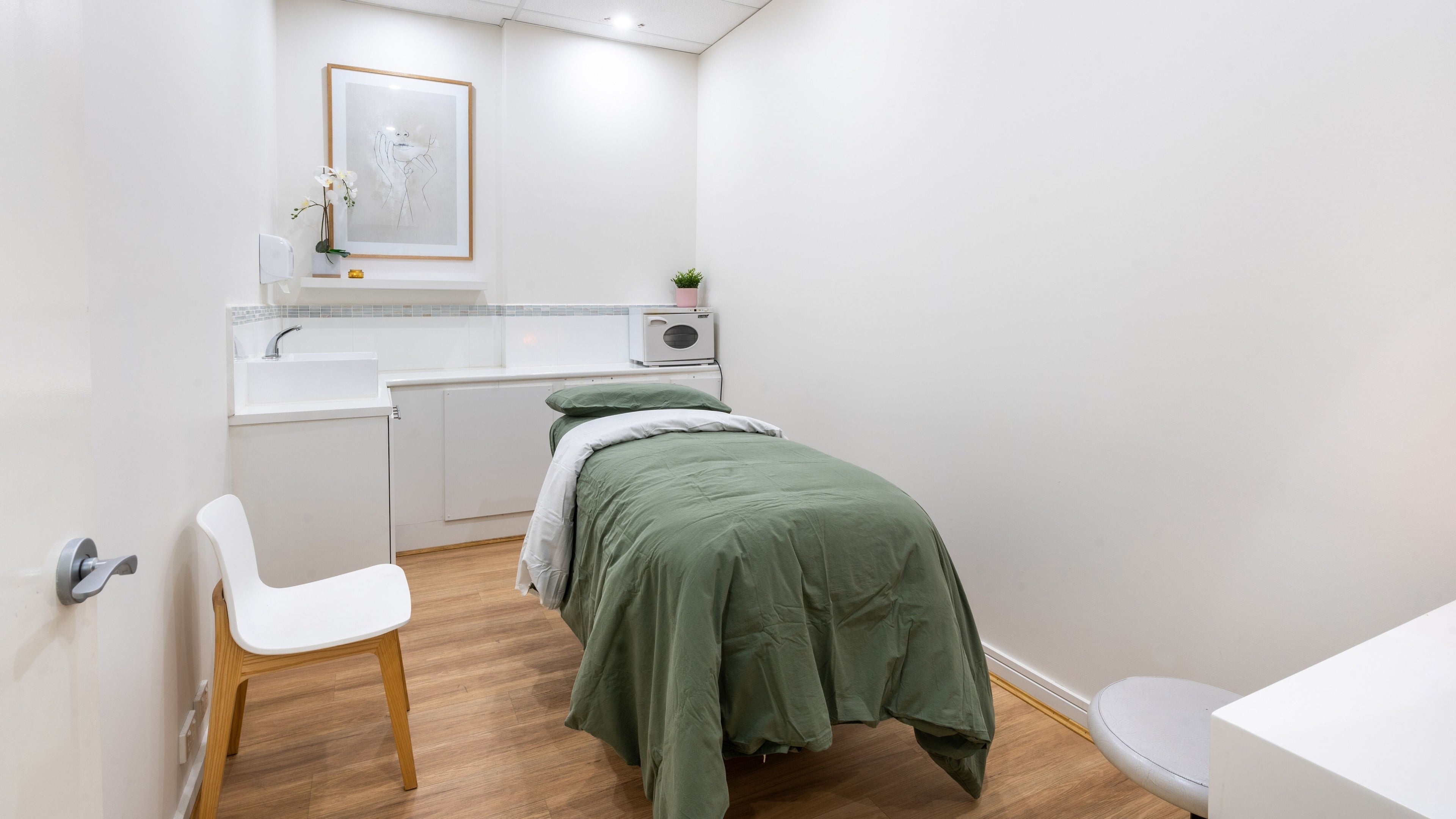 Serene treatment room at Kay + Co Cosmetic Rejuvenation - Highett, in Highett, Victoria, AU featuring a cozy bed.