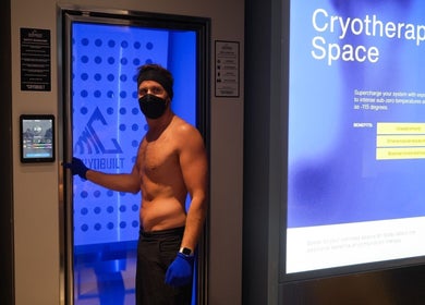 Cryotherapy chamber in Super-Young, Armadale, Victoria, AU with person preparing for session.