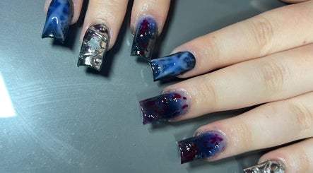 Artistic nail design at Nailzbycharl, Swansea, Wales, GB featuring cosmic patterns and metallic accents.