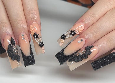 Intricate floral nail art with black and nude design at Nailzbycharl, Swansea, Wales, GB.