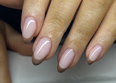 Elegant nude nails with a glossy finish at Nailzbycharl, Swansea, Wales, GB. Perfect for any occasion.