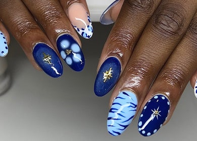 Beautiful blue nail art at Nailzbycharl in Swansea, Wales, GB, featuring intricate designs and embellishments.