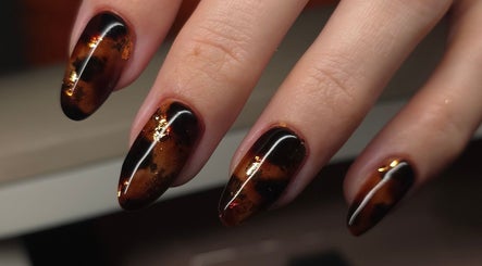 Close-up of elegant amber nail art at Nailsbyasha in Toronto, Ontario, CA showcasing intricate design.