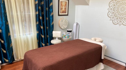 Tranquil massage room at Dana Jayne, Cmt in Oakland, California, US featuring elegant decor and a cozy massage bed.