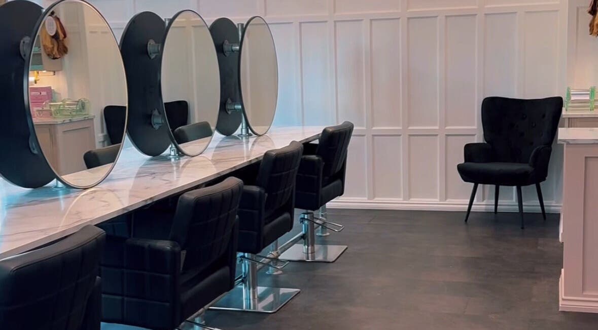Modern salon interior at Crowned Hair by Emily, Carlisle, England, GB, featuring chic styling chairs and mirrors.