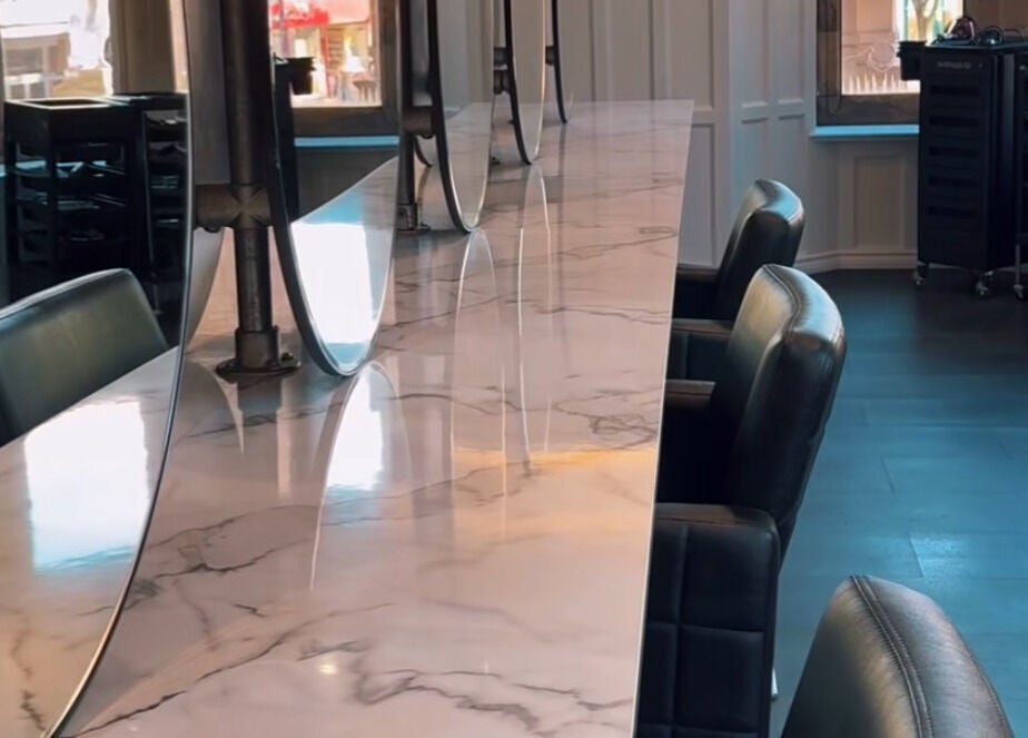 Sleek marble countertop with modern mirrors at Crowned Hair by Emily, Carlisle, England, GB.